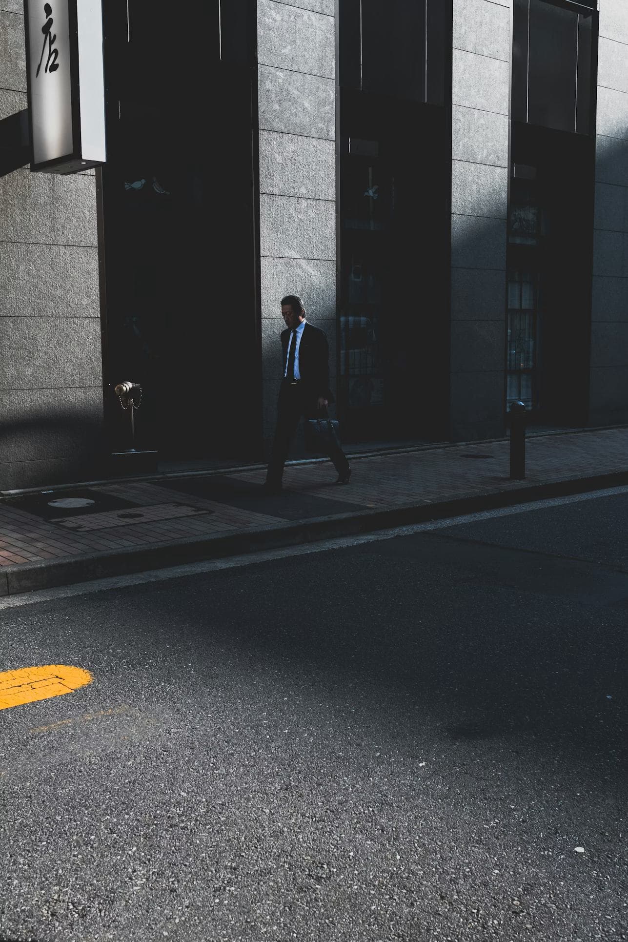 A leader walking alone through morning light